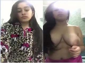 Watch a stunning girl strip down and reveal her ample breasts