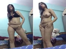 Exotic Indian girl with a seductive look performs a money dance striptease