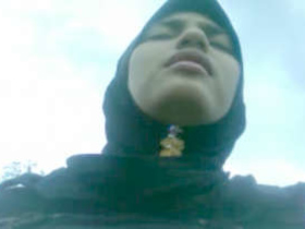 A charming girl wearing a hijab reveals her breasts and genitals