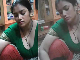 Aunty's natural breasts and cleavage in a steamy video