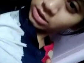 Desi girl with a pretty face and big tits in a hot video