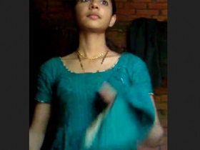 A youthful woman undresses and playfully entices in a rural setting