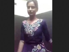 A young Indian woman reveals her body as she removes her clothing on camera