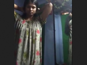 Tamil girl with a slender figure changes her clothes in a village