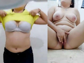 Aroused African-American woman flaunts her large breasts and pleasures herself