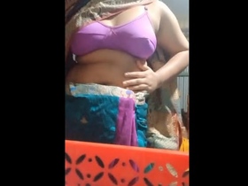 A young woman from Bangladesh reveals her curves in a Shari dress