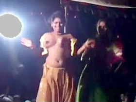 Sensual Indian dance performance in open-air village setting