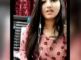 A young and attractive Indian college girl reveals her breasts on a webcam