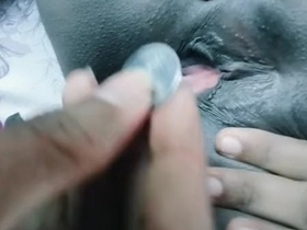 Indian woman inserts coin in her pussy for pleasure
