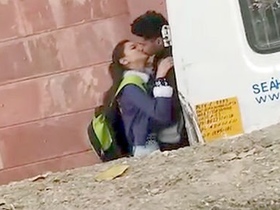 Amateur Indian teens kiss passionately in a college setting
