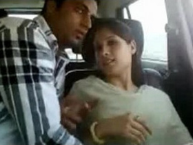 A young Indian woman pleasuring herself and performing oral sex in a vehicle