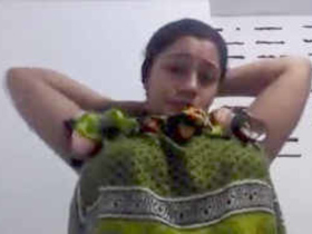 Aroused mature woman with large breasts displays herself