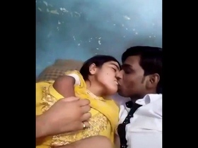 A passionate Desi couple smooching and pressing on their breasts