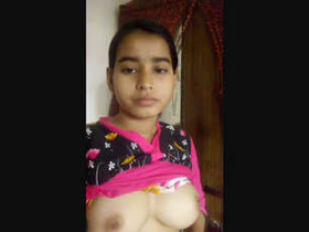 A beautiful woman of South Asian descent showcases her body and masturbates with her hands