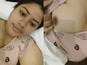 Young girl flaunts her breasts in a seductive manner
