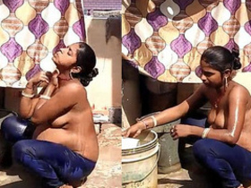Indian aunt takes a bath outdoors