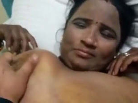 A mature woman from Tamil, India engages in sexual activity