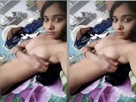 A stunning girl flaunts her breasts and pleasures herself with her hands
