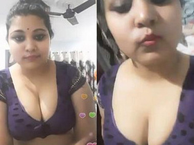 Voluptuous Indian woman with large breasts removes her saree and displays her stomach in a provocative manner