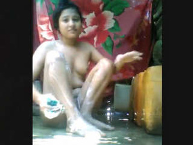An Indian college student indulges in risque behavior while bathing, capturing the moment themselves