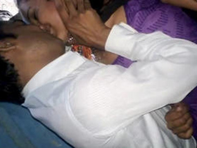 Indian pair passionately kissing in a purple salwar suit in a rural setting