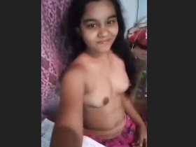 A charming Indian teen playfully pleases with her sensual display