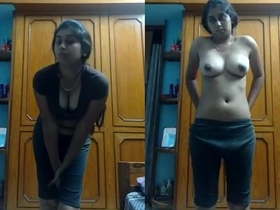 A gorgeous young woman undresses and masturbates