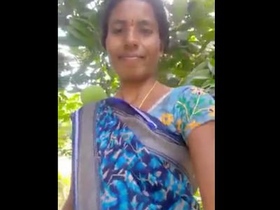 Indian village woman reveals her intimate parts in an open-air setting