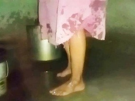 Desi aunty takes a bath in her home in the village