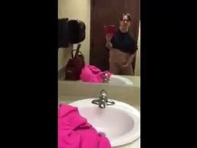 Amateur girl pleasures herself in public restroom