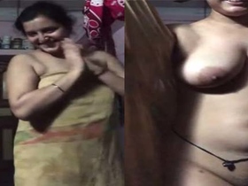Indian aunty shows off her big boobs and hairy pussy