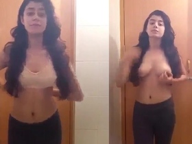 A stunning young girl strips naked and showcases her beauty in the bathroom