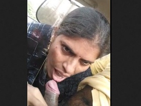 Mature Randi gives a blowjob in a car to a client