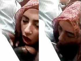 Arab woman in hijab gives oral pleasure in a car